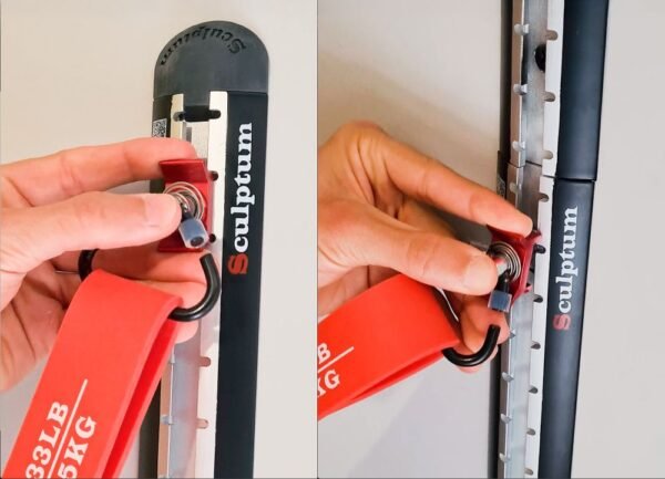 detalle-anclaje-regulable-bandas-elasticas-sculptum Primer plano de mano ajustando anclaje móvil en rail de pared para bandas de resistencia rojas